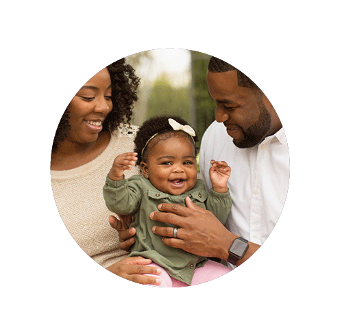 black baby laughing with black parents