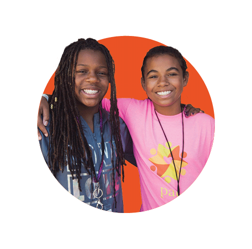 two black children smiling in red circle